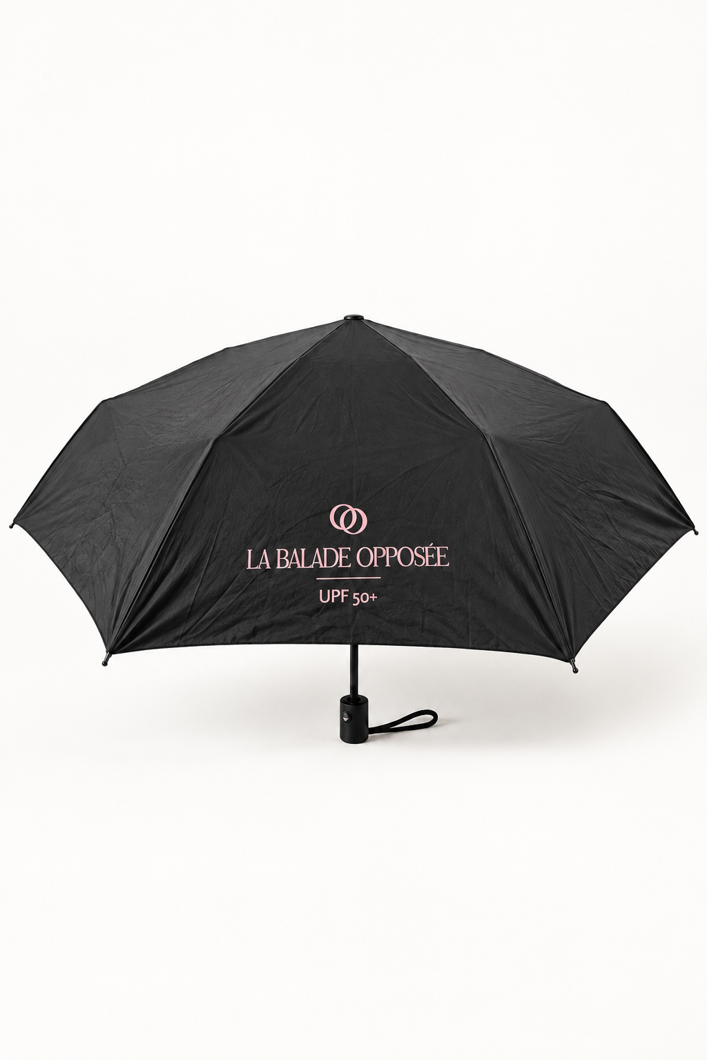 Parapluie UV noir La Balade Opposée présenté sur fond blanc.